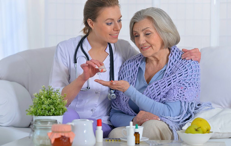portrait of a nurse taking care of an elderly woman