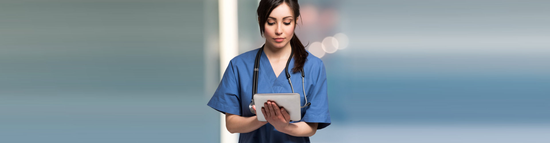a female nurse on a tablet