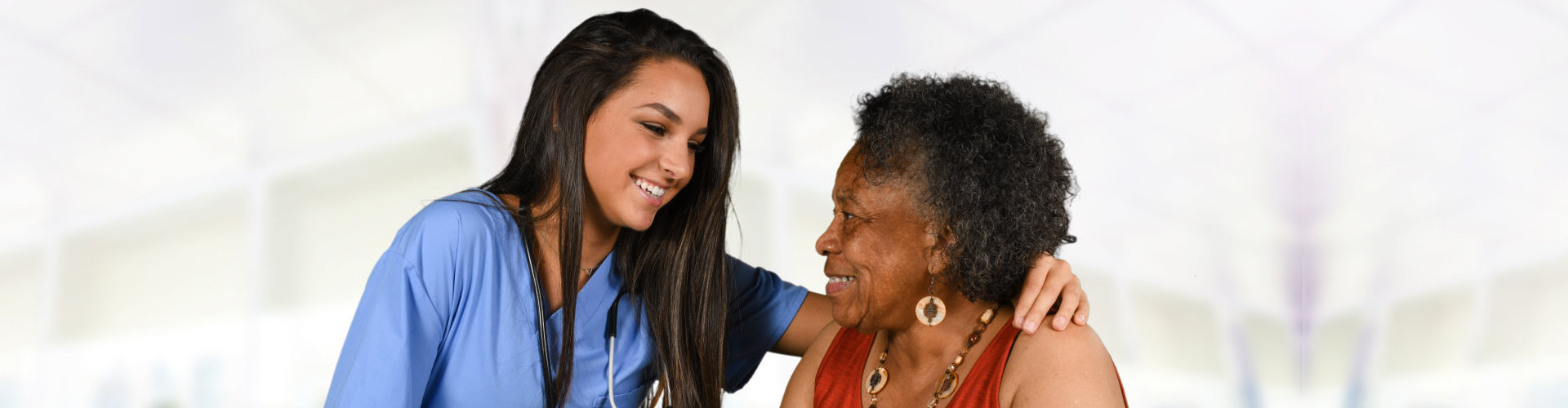 nurse attending to elderly woman
